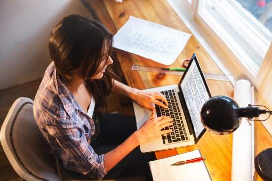 SEO expert typing on laptop